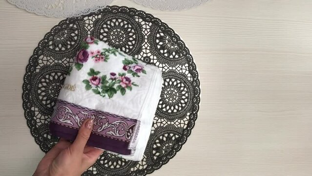 The woman makes a review of the purchase. He takes out terry towels from the package. Lays on the table. Close-up. Vertical video.