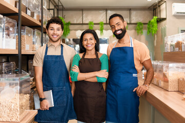 Service team poses for portrait in grocery store.