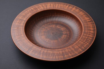 One ceramic bowl on black background, closeup