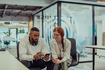 Naklejka na ściany i meble In a modern office African American young businessman and his businesswoman colleague, with her striking orange hair, engage in collaborative problem-solving sessions