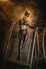 Beautiful woman in the cat mask posing at night city street concept.