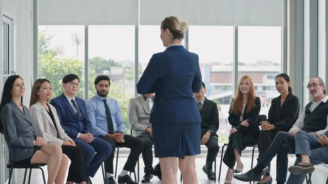Business people attending seminar in boardroom. Corporate businessteam and manager in meeting. Woman manager talking with diverse corporate colleagues in seminar. Business meeting 
