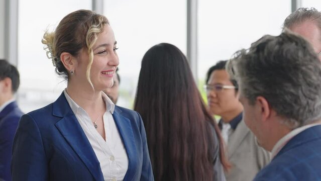 Caucasian man leader introducing woman manager to new team partner at seminar of company. Male leader introducing woman manager shaking hands welcoming newcomer
