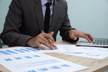 Businessman working at office with digital tablet, laptop computer, smart phone. Professional...