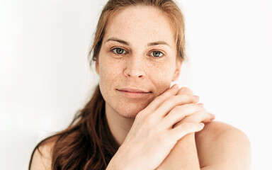 Close-up portrait of a natural redhead woman on a white background. Natural authentic beauty.