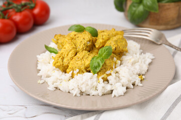 Delicious rice and chicken with curry sauce on white textured table, closeup