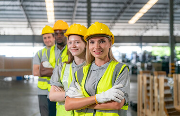 Team of warehouse employees working on inventory in a large distribution warehouse. Business factory industry concept.
