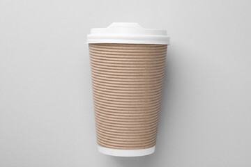 One paper cup on light grey background, top view. Coffee to go