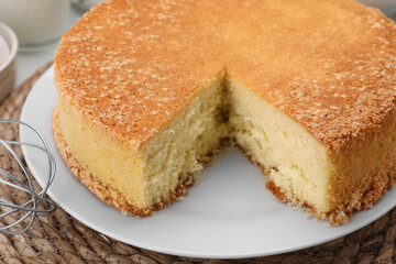 Cut tasty sponge cake on table, closeup