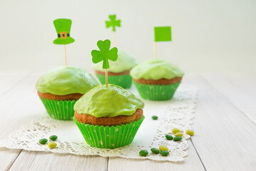 Homemade green cookies with shamrock flag on a table