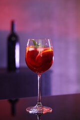 Glass of delicious refreshing sangria on counter in bar