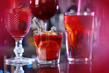Many glasses of delicious refreshing sangria on counter in bar, closeup