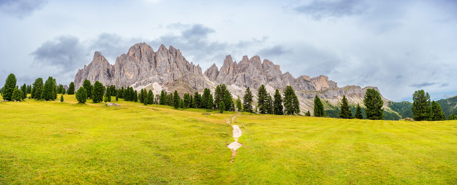 Dolomite landscape in Puez Odle Nature Park - view from alpine plateau with green meadows, Italy