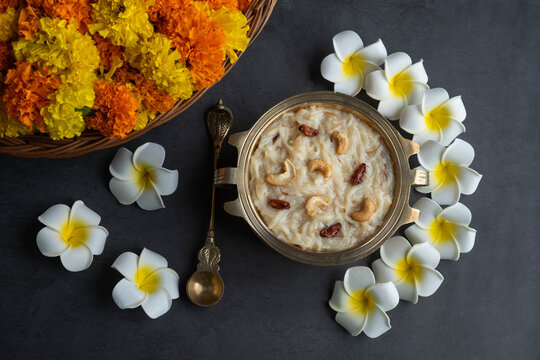 Onam special food image, Kerala sweet dessert semiya payasam or khir payasam with flowers on the background