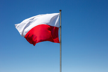 Old Polish flag against the sky