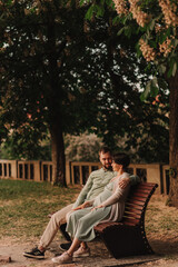 Husband with his pregnant wife walking in park. Happy family concept photo. No focus blurred and noise effect