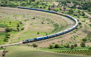 Express passenger train passing over a huge curve in a place named Daundaj, Maharashtra, India