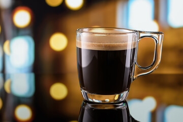 Glass cup of espresso coffee on the bar counter with blurred background. Copy space.