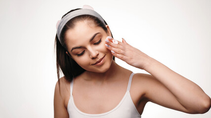 Woman cleaning face with white pad