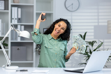 Portrait of joyful happy and successful business woman inside office, Hispanic woman smiling...