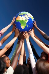 a group of diverse people holding a globe with their hands raised in unity