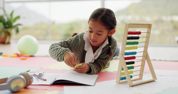Math, assessment and kid counting for learning numbers doing homework as development with a colorful toy. Mathematics, education and child or girl with knowledge on a kindergarten school floor
