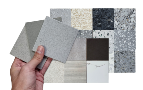 architect hold quartz samples compare color with multi texture of square shapes terrazzo artificial stone samples and porcelain ceramic stone tile samples isolated on background with clipping path.