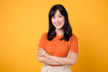 Experience confident vibes with a young Asian woman in her 30s, donning an orange shirt, showcasing...