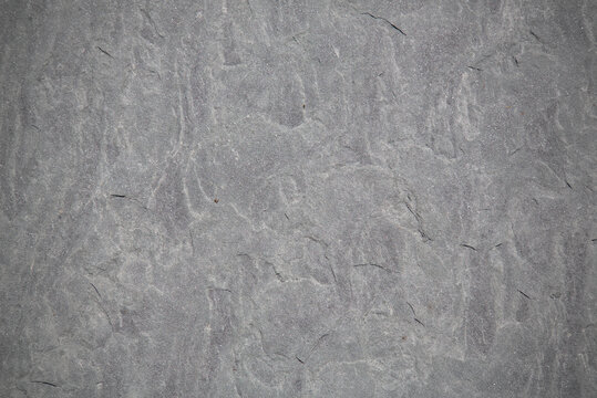 stone texture background (natural granite, shale, bluestone, flagstone, basalt, concrete graphic resource) stained, rough and smooth vignette (room for text, copy, logo placement)