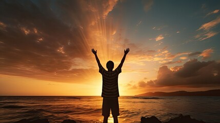 Fototapeta premium Boy s silhouette in sunset over sea representing religion worship prayer and praise