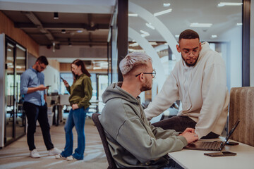 Young group of business people brainstorming together in a startup space, discussing business projects, investments, and solving challenges.