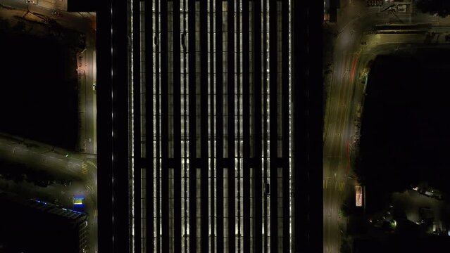 Fly above Hauptbahnhof at night. Birds eye shot. Light shining through translucent roof. Zurich, Switzerland