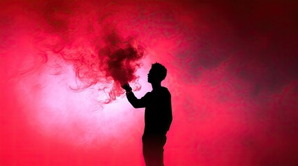 A man with a red smoke stick captured in silhouette