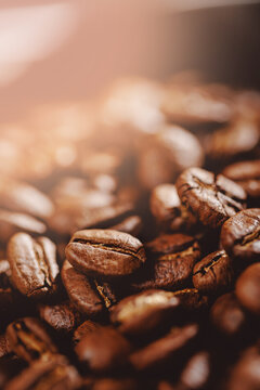 Macro photo fresh roasting coffee beans, brown sun light toning