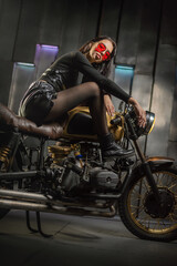 Plakat Young beautiful girl with dark hair on the old motorbike.
