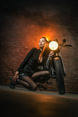 Fototapeta na wymiar Young beautiful girl with dark hair on the old motorbike.