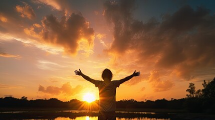 A curly guy with open hands admiring the stunning summer sunset silhouette