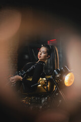 Plakat Young beautiful girl with dark hair on the old motorbike.