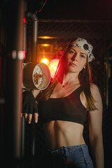 Plakat Girl with the wrench tool posing in the dark. Mechanic concept.