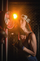 Obraz na płótnie Canvas Girl with the wrench tool posing in the dark. Mechanic concept.