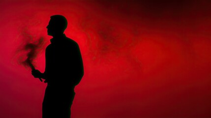A man with a red smoke stick captured in silhouette