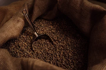 Fotobehang From above of metal scoop in burlap bag filled with aromatic roasted coffee grains © arthurhidden