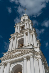 Fototapeta na wymiar Kalyazin, Russia, July 3, 2023. View of the bell tower with a spire and a cross.