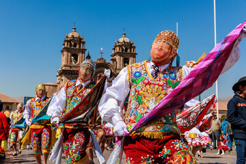 Dancers in typical costumes celebrate in honor of the Virgen del Carmen, in the square of Cusco,...