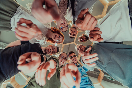 In a modern office, a group of young business professionals is captured in a warm and embracing hug, reflecting the spirit of unity, collaboration, and shared success in their dynamic workplace.