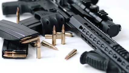 High angle dolly in towards loaded assault rifle with a small amount of ammunition in the...