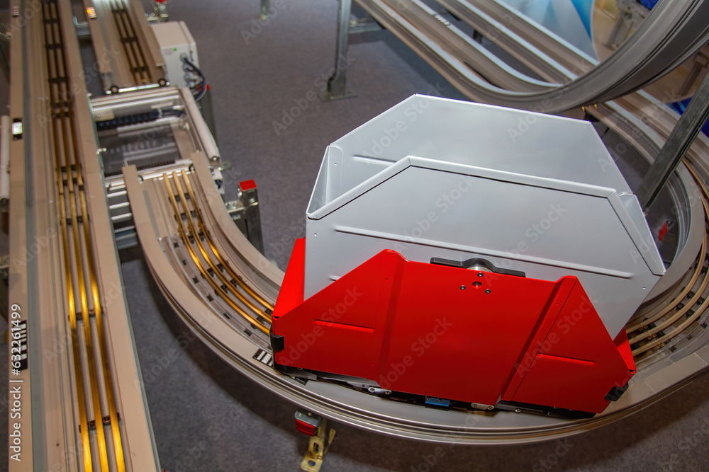 Poster automated conveyor. narrow production line. plastic box on conveyor. automated equipment in library.