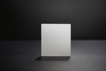 Fototapeta premium A white box is sitting on a black surface