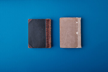 Two beautiful vintage small format books with scuffs and scratches on black and gray hardcovers. Old books, vintage editions, love of reading, book collecting