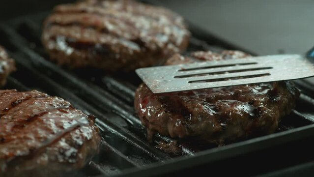 Hamburger on grill in slow motion